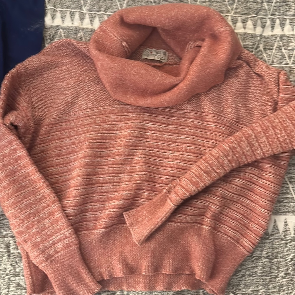 Cute pink and white sweater.